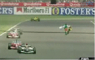guy runs at racing cars during race gifrific